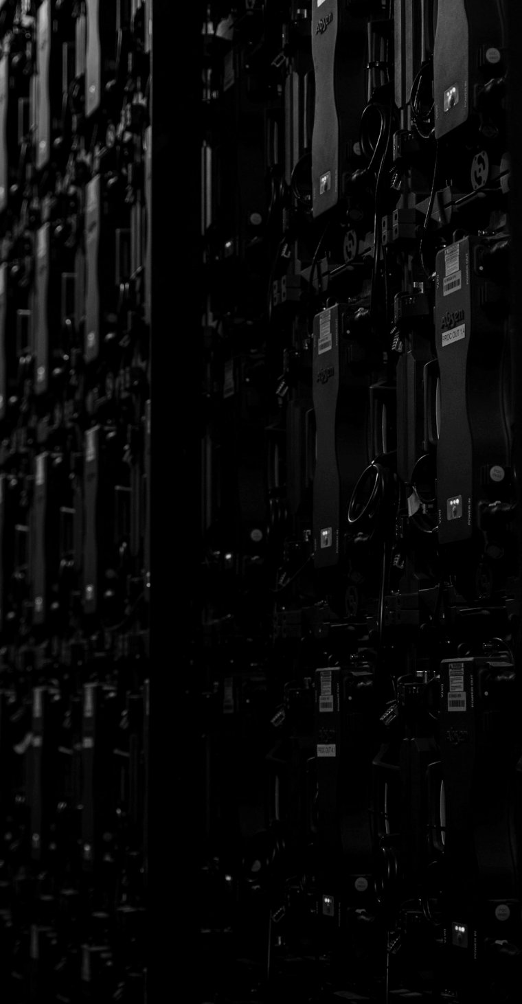 Rows of server racks in a dark data centre