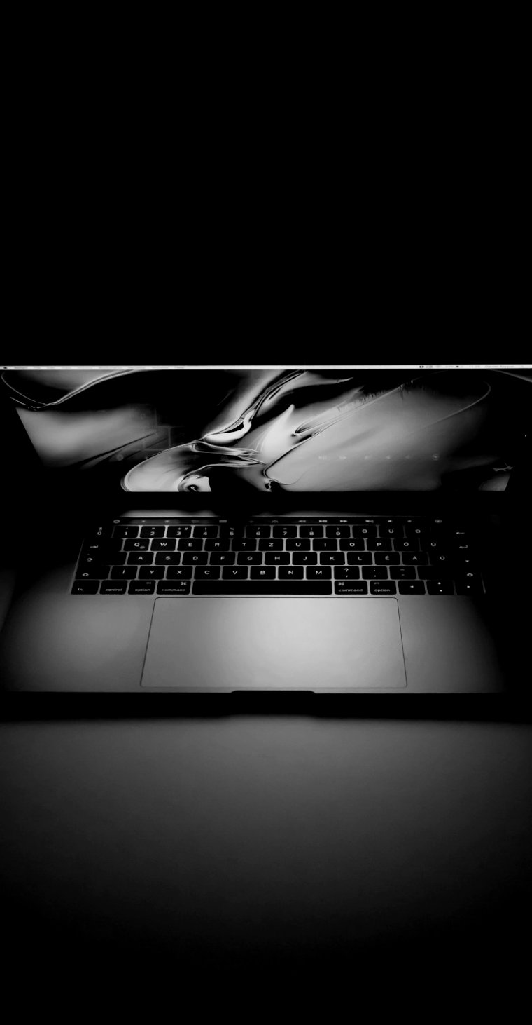 Laptop glowing on a dark desk