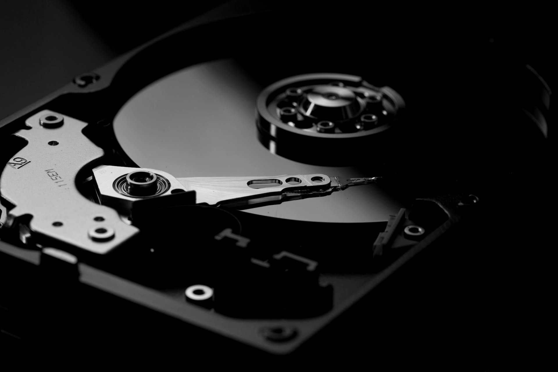 Close-up of an open hard disk drive showing the platter and read arm