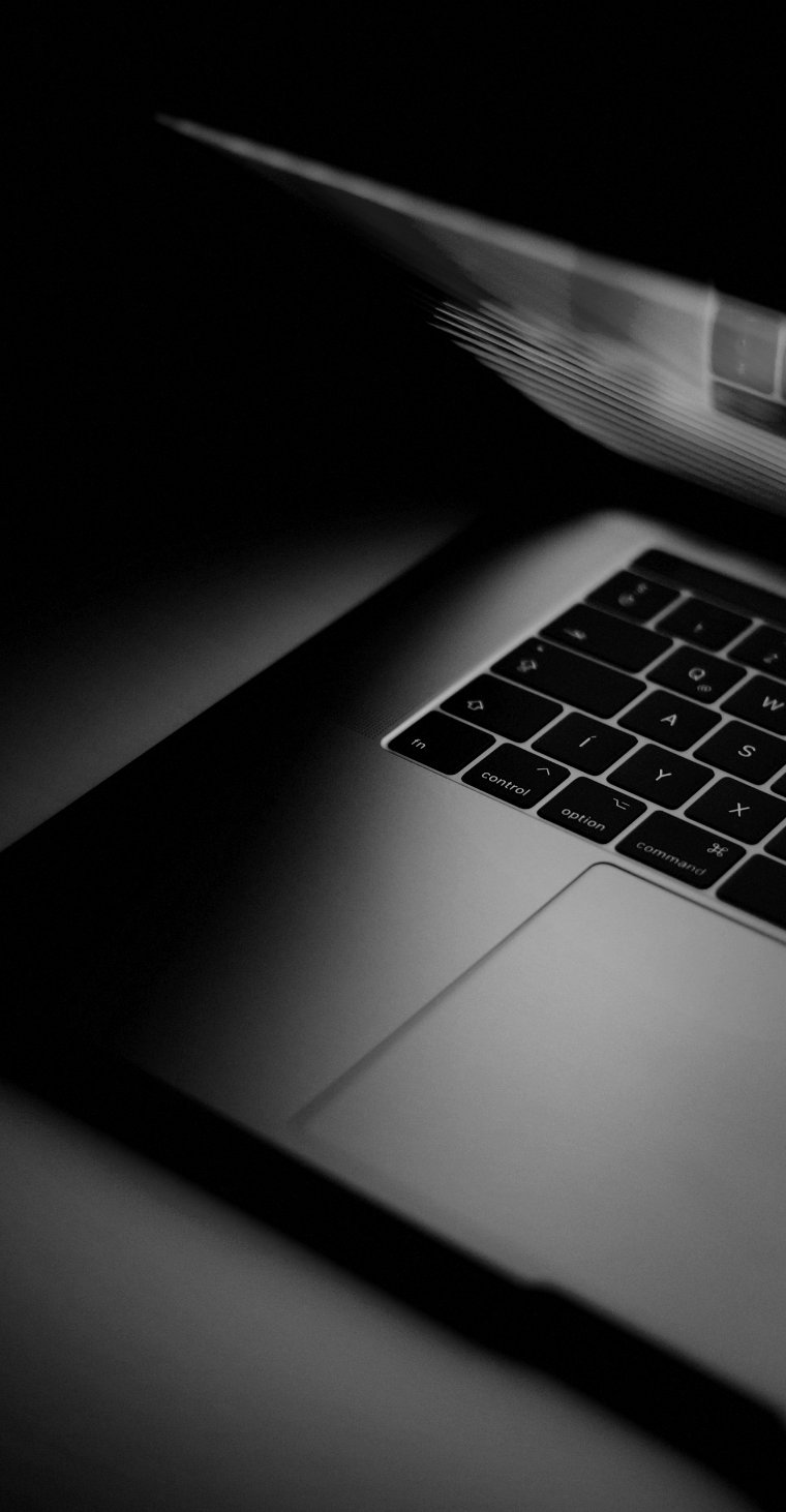 Laptop half open glowing in the dark